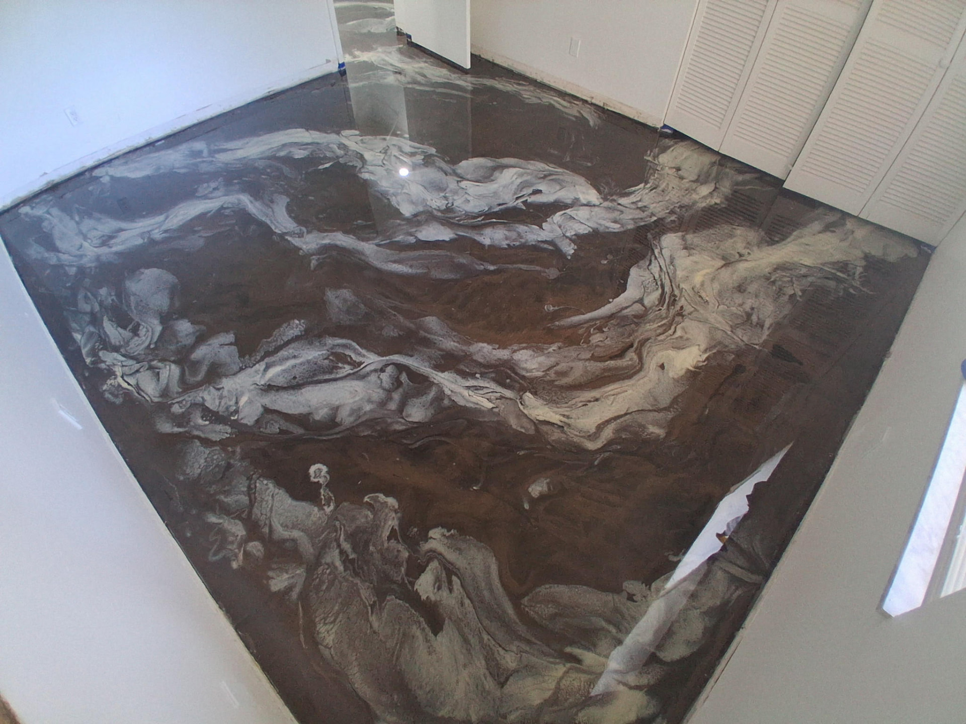 Brown and pearl metallic epoxy floor in a Cocoa Beach condo living room