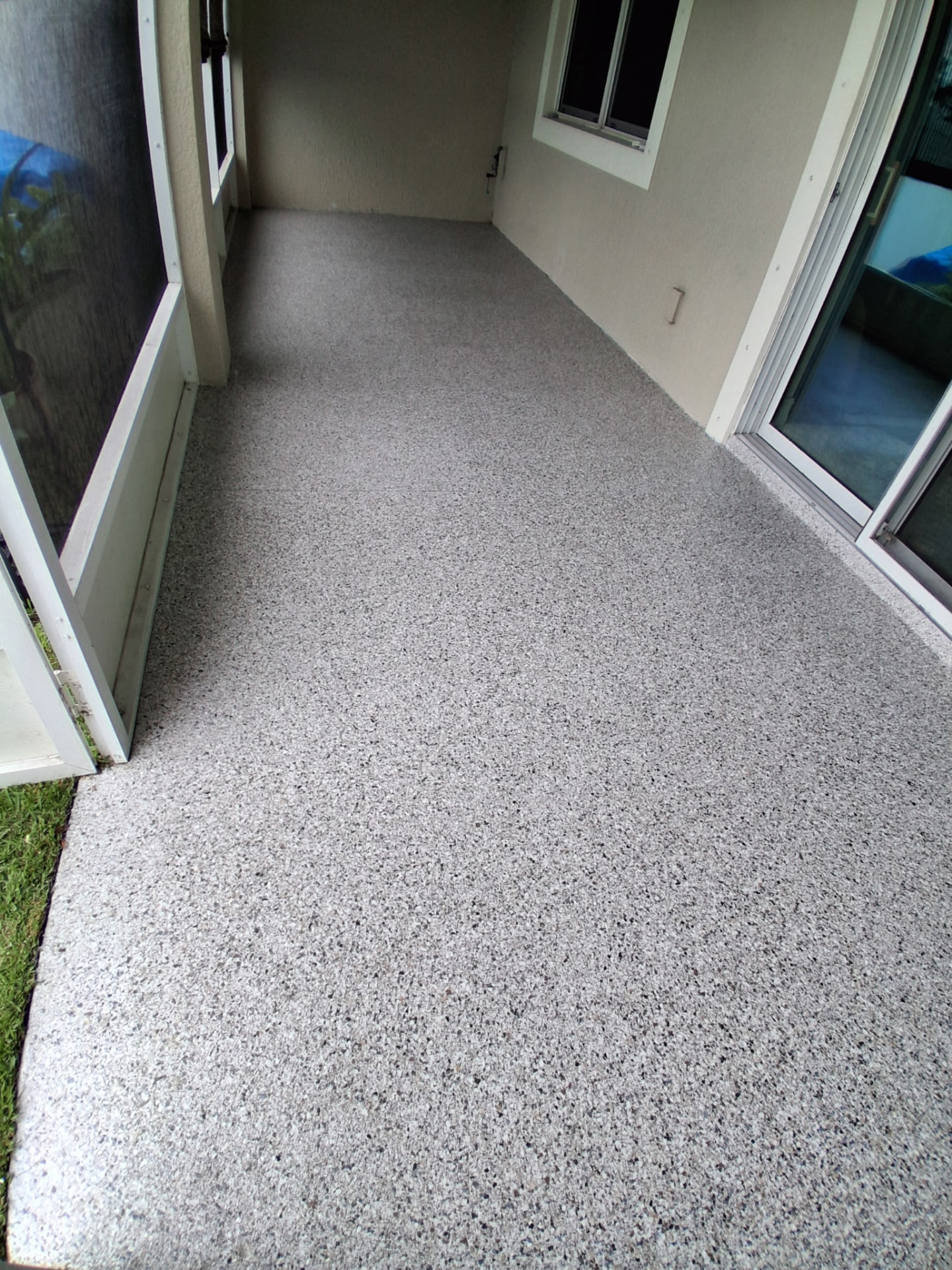 Gray flake epoxy coating on a screened lanai walkway in Viera, FL