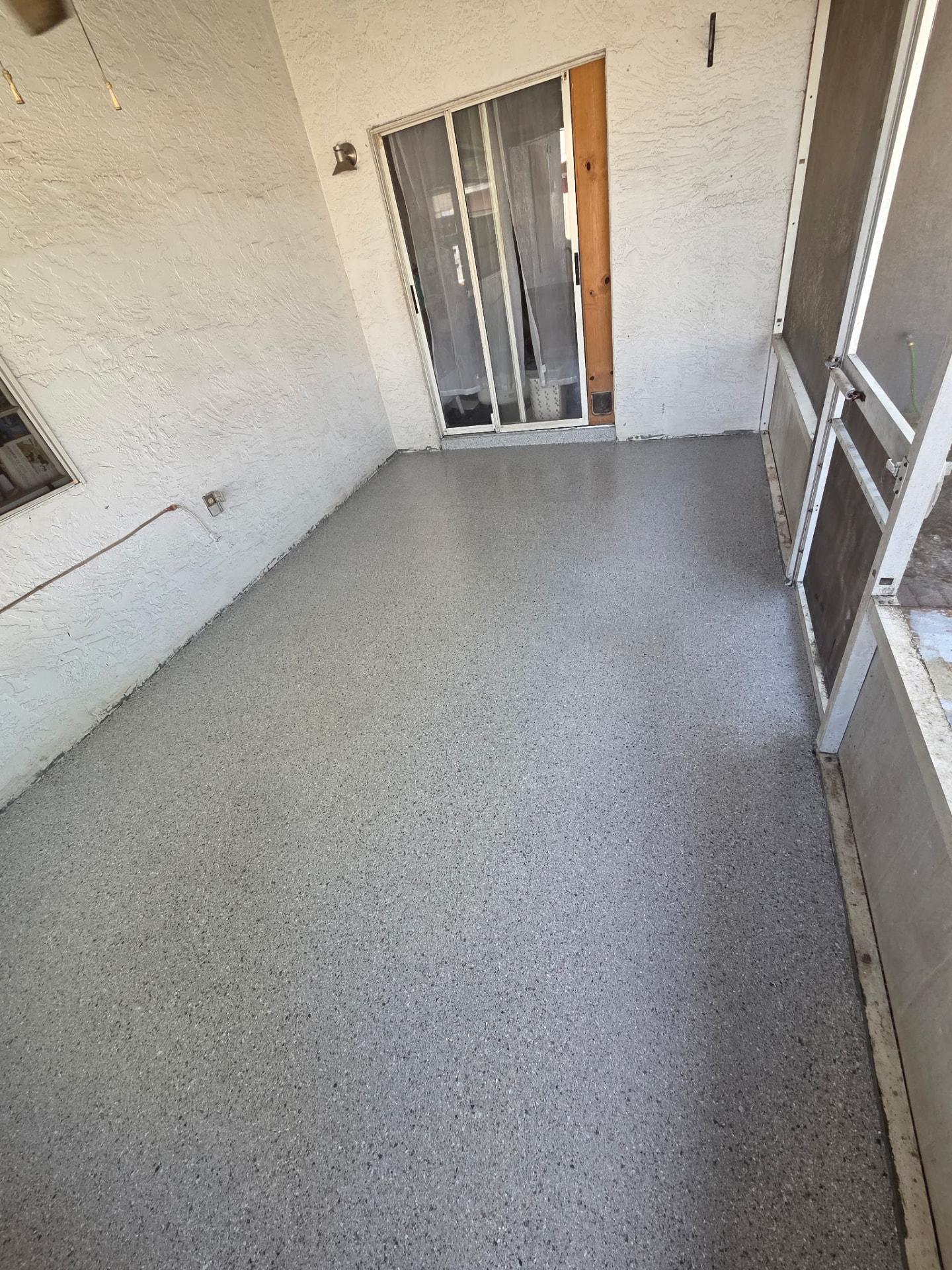 Screened porch finished with gray epoxy flake and polyaspartic topcoat in Cocoa, FL