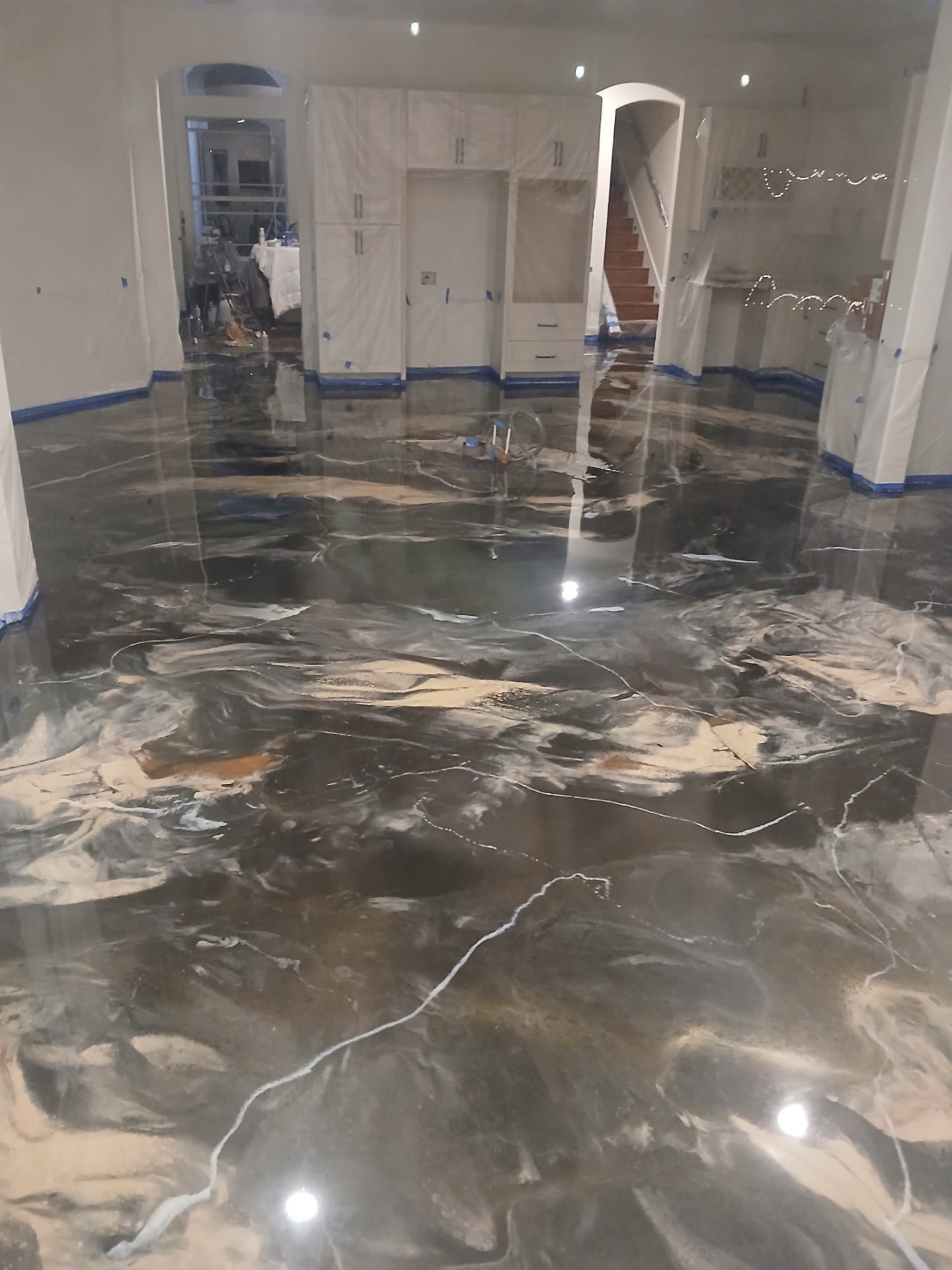 Glossy brown and pearl metallic epoxy floor in a residential kitchen interior