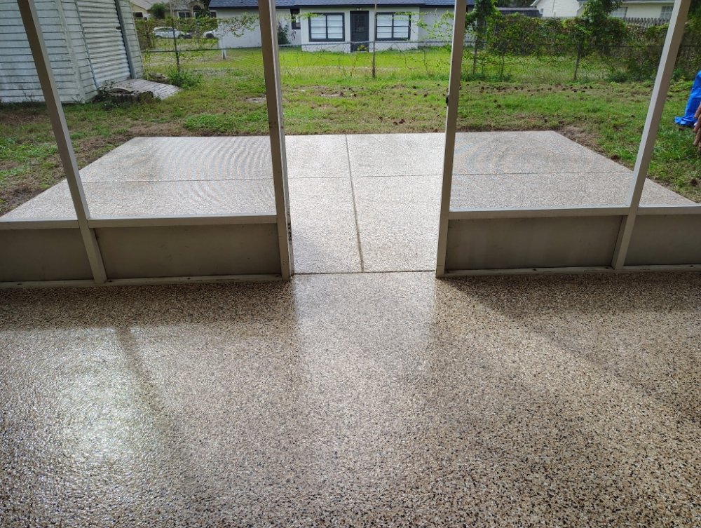 Tan and brown speckled flake epoxy coating flowing from a screened porch out to a concrete patio on the Space Coast