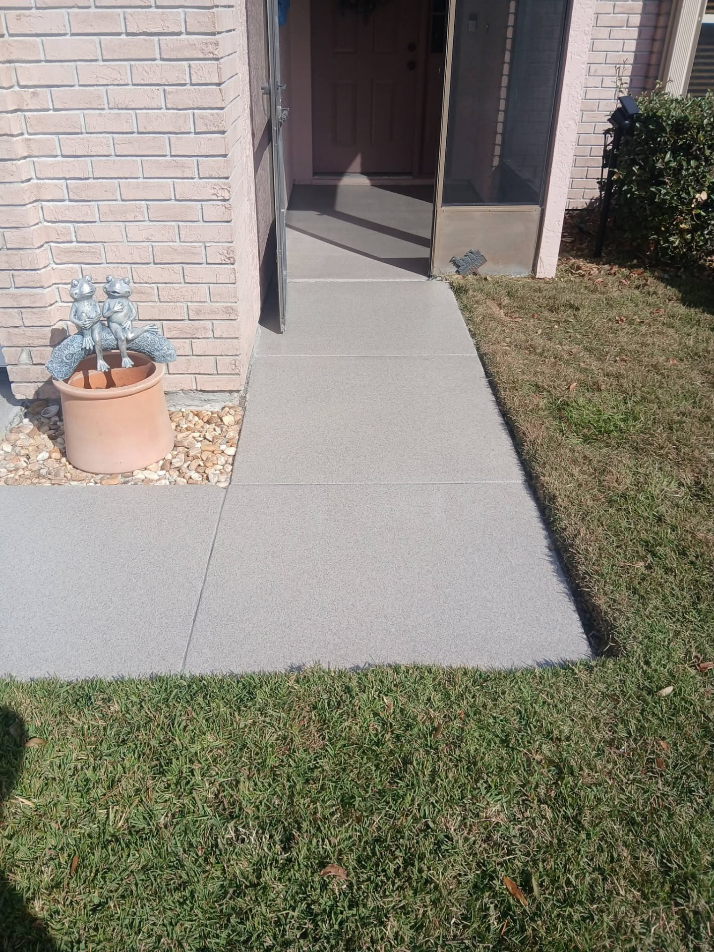 Gray flake epoxy coating on a front walkway and entry porch