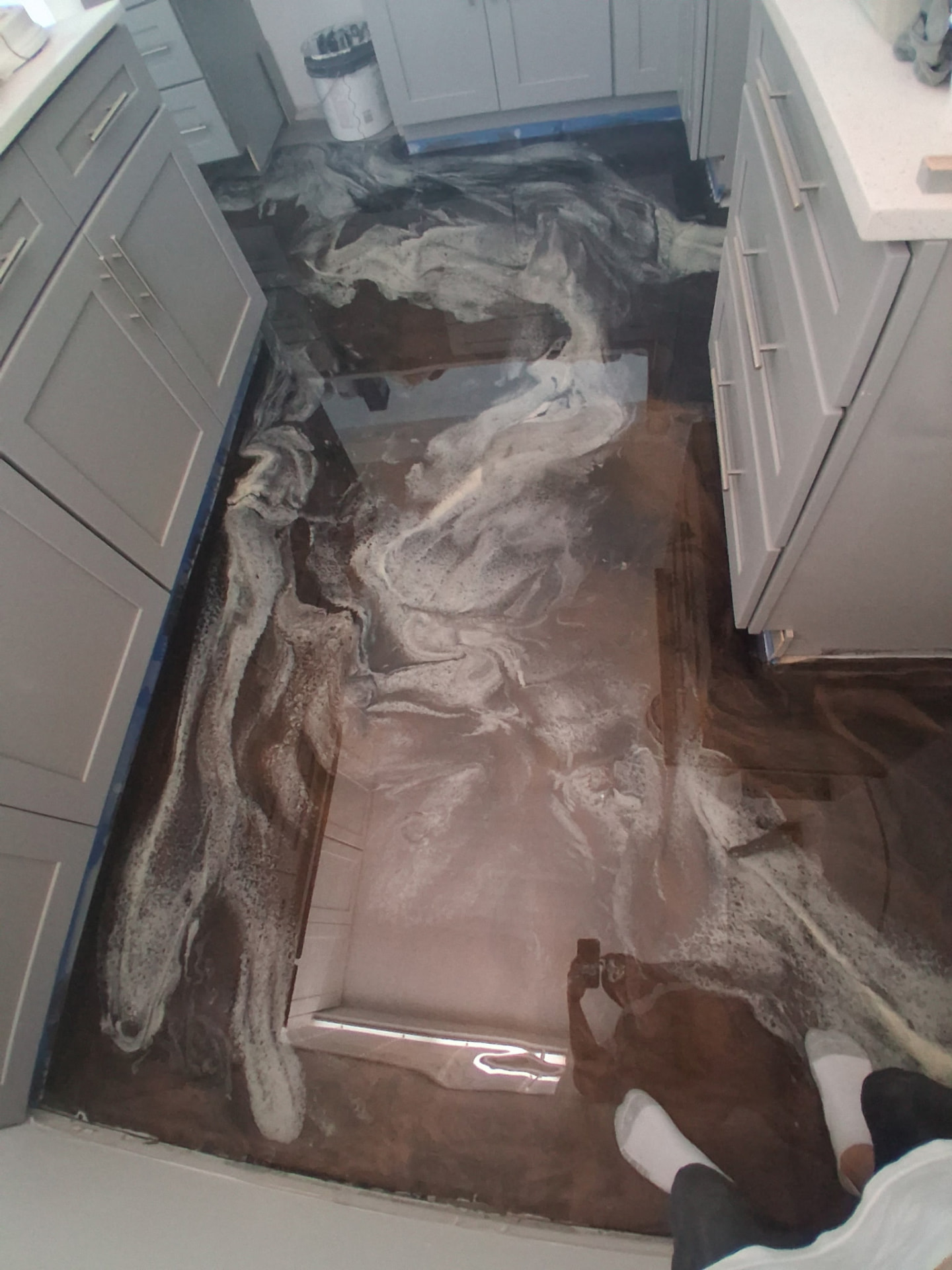 Brown and pearl metallic epoxy floor in a Cocoa Beach condo bathroom