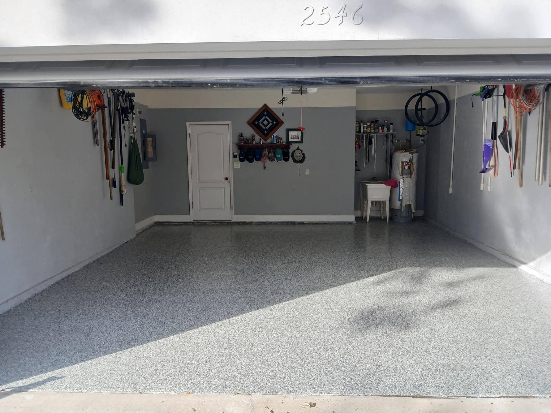 Gray and white full-broadcast flake epoxy floor in a two-car garage