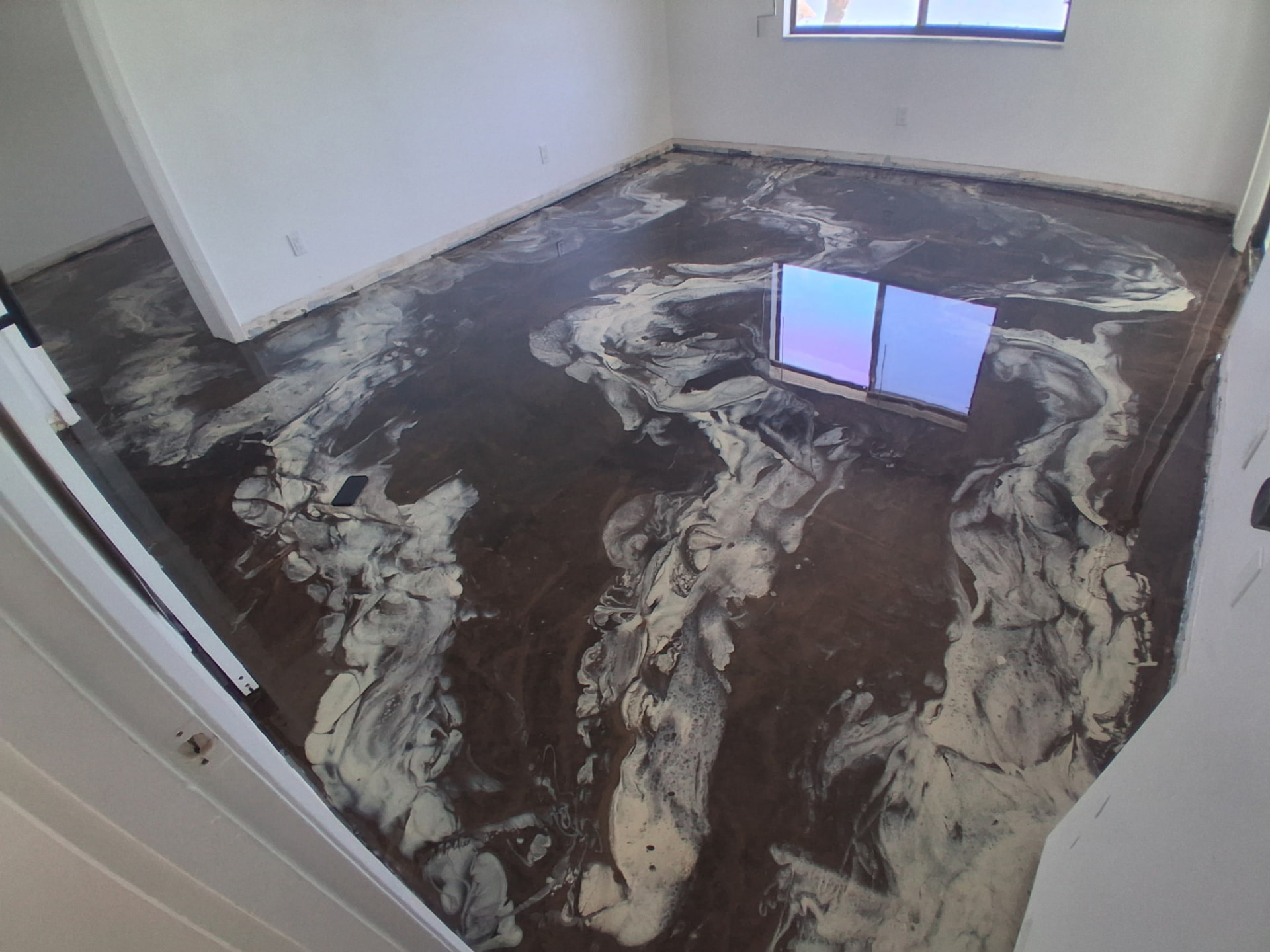 Brown and pearl metallic epoxy floor in a Cocoa Beach condo master bedroom
