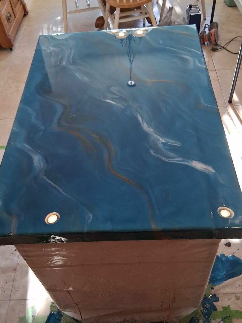 Aqua-blue metallic epoxy coating on a custom kitchen island countertop in Cocoa Beach